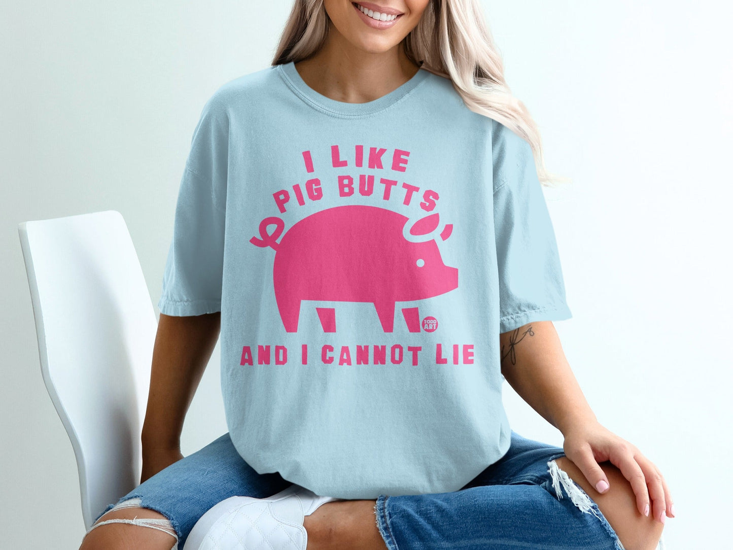 Light blue t-shirt with pink pig graphic and text "I like pig butts and I cannot lie".