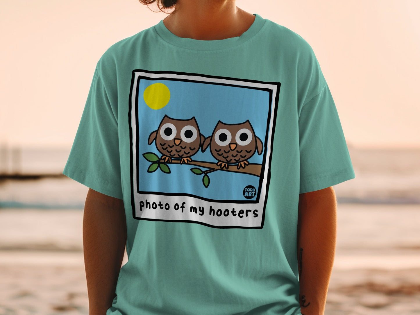 Two cartoon owls on a branch with "photo of my hooters" text.
