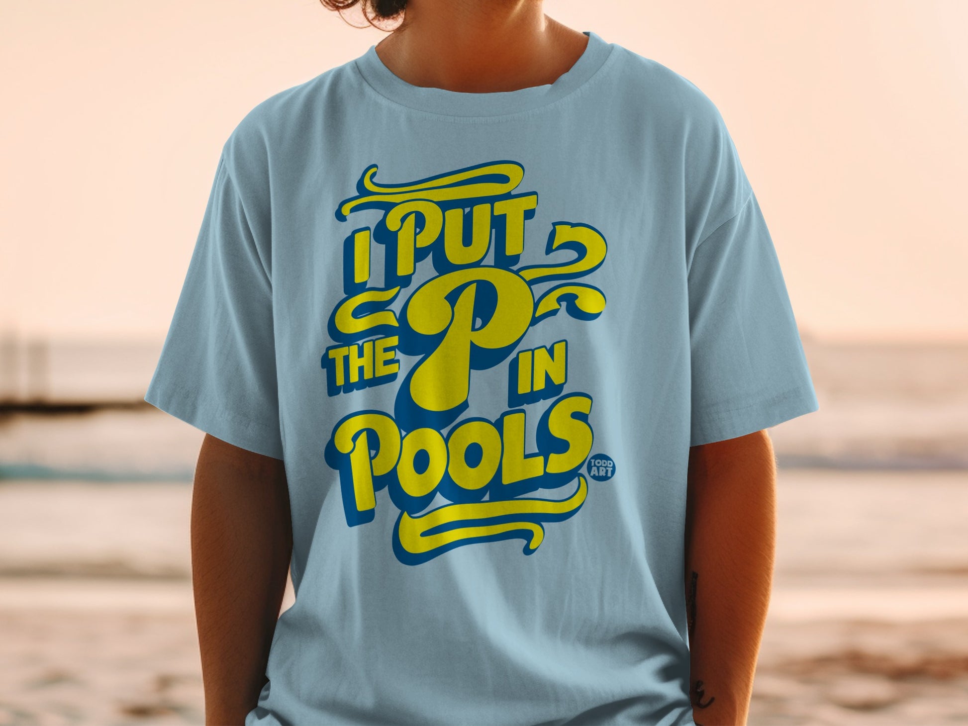 Light blue t-shirt with yellow text reading "I PUT THE P IN POOLS".
