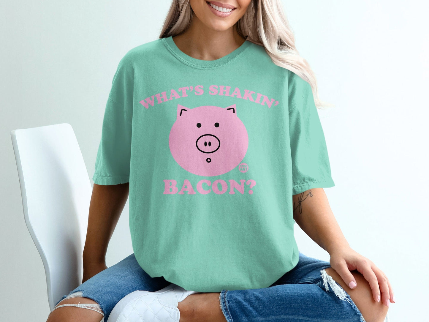 Teal t-shirt with "What's Shakin' Bacon?" text and a cartoon pig face.