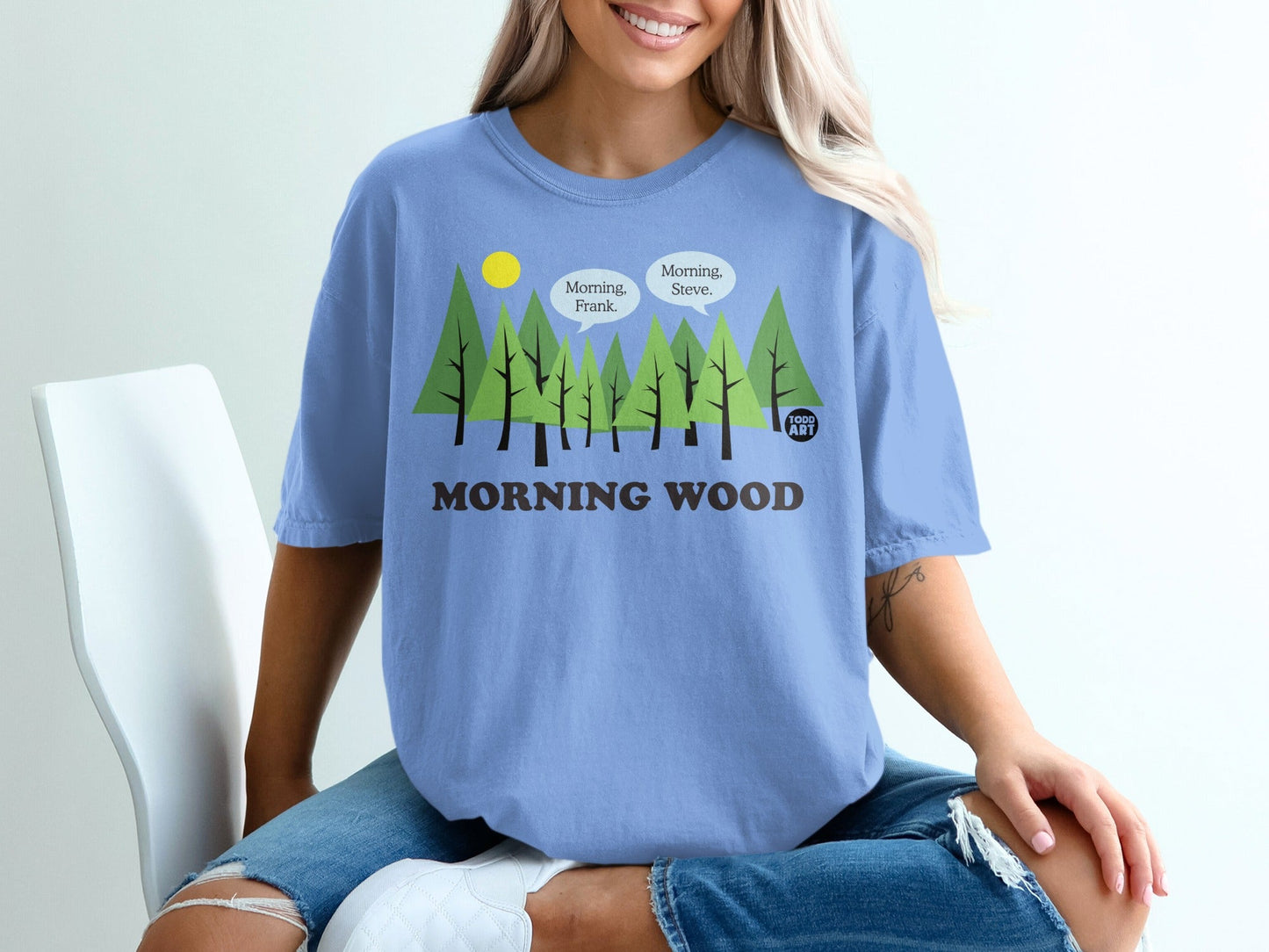Light blue t-shirt with cartoon trees and "Morning Wood" text.
