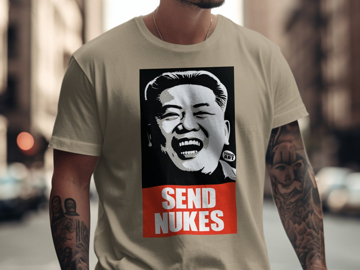 T-shirt with portrait of Kim Jong Un and "SEND NUKES" text.