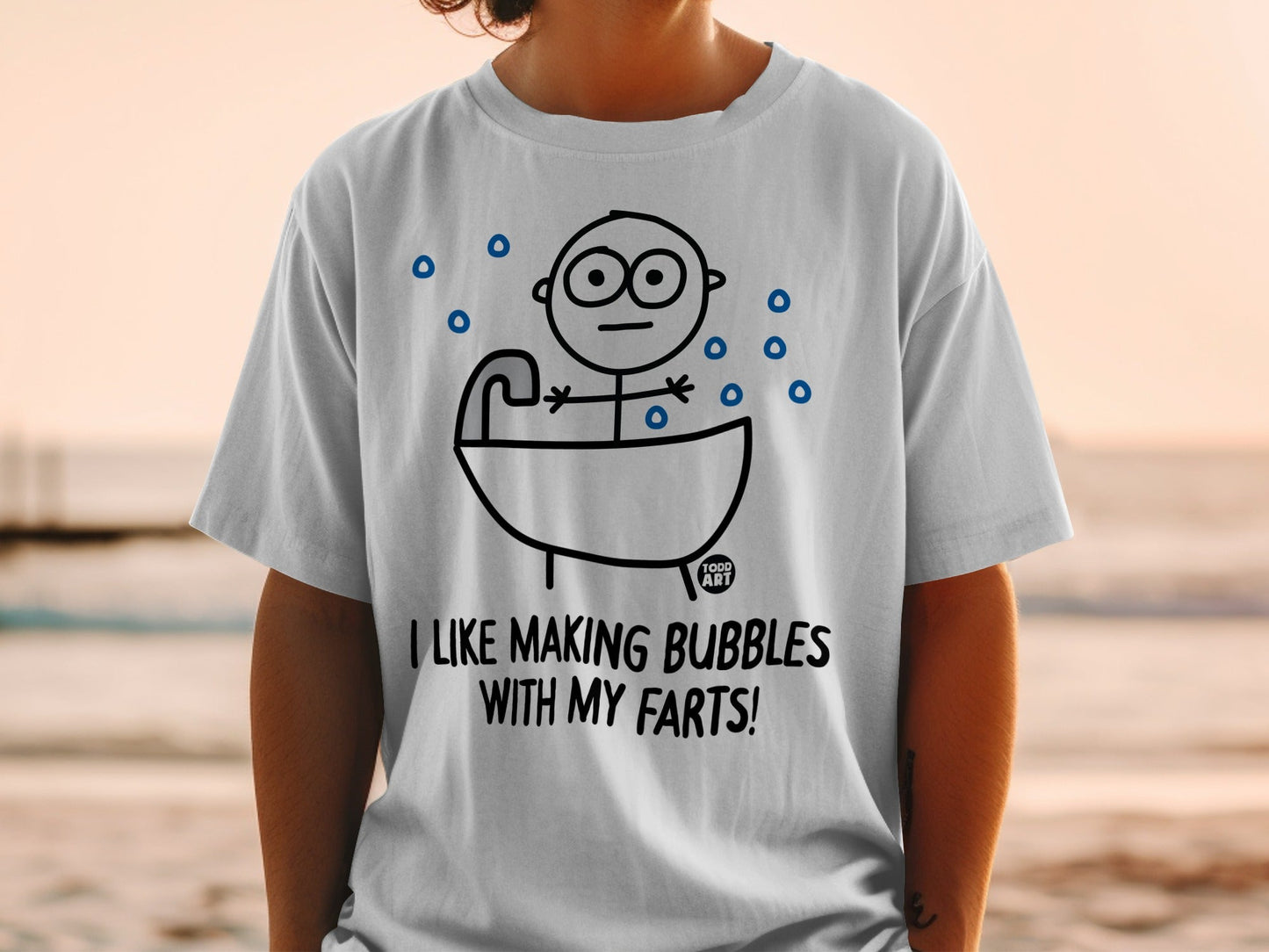 White t-shirt with cartoon man in bathtub and text "I LIKE MAKING BUBBLES WITH MY FARTS!".