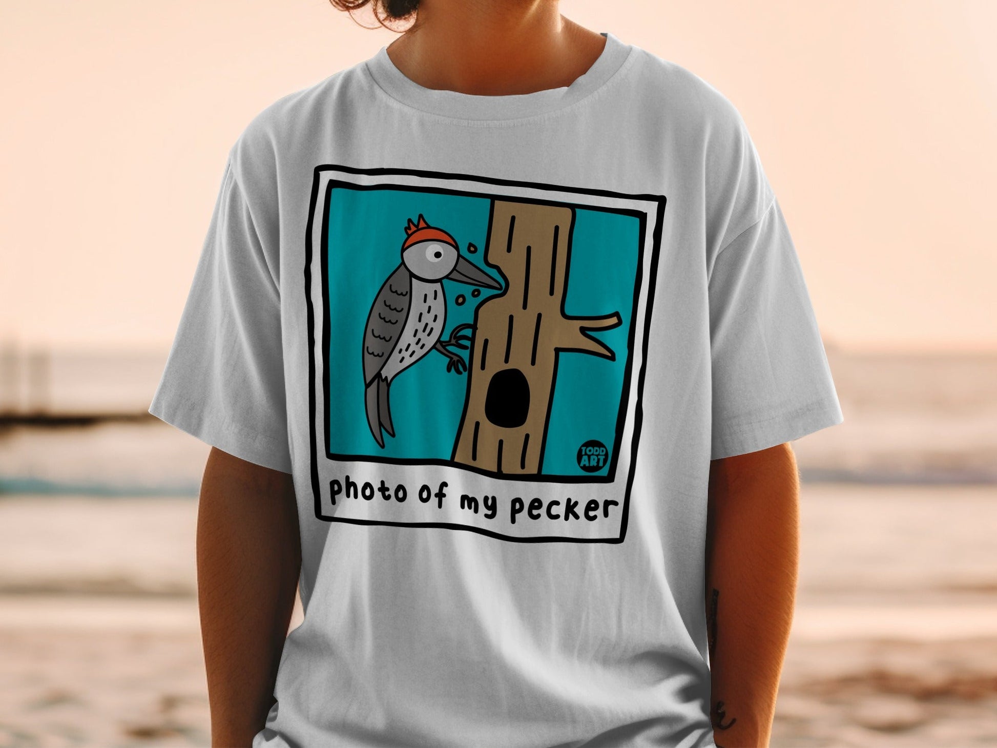 Cartoon woodpecker pecking at a tree with text "photo of my pecker".