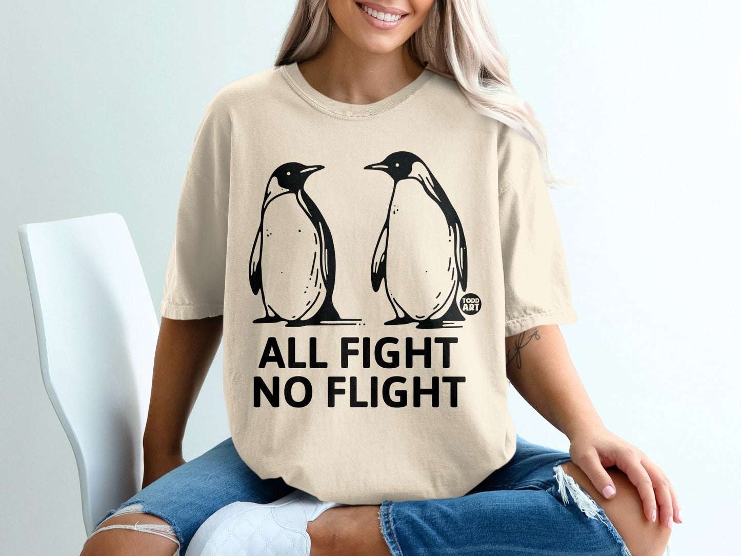 T-shirt with two penguins and text "ALL FIGHT NO FLIGHT".