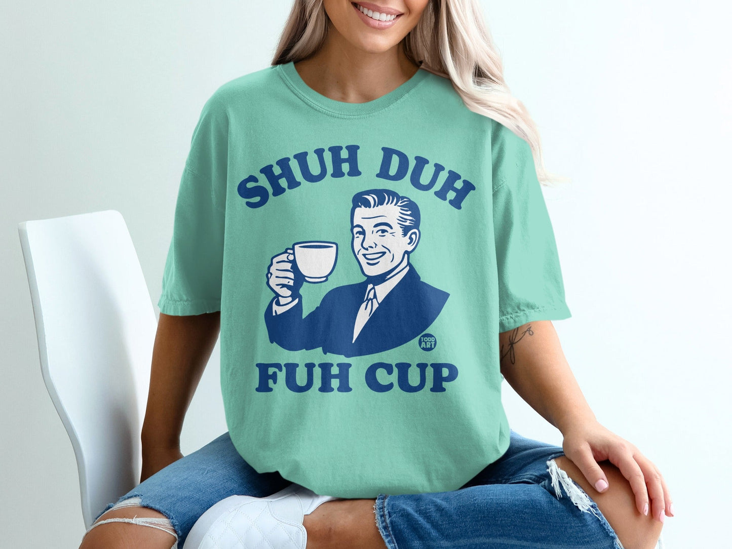 Teal t-shirt with "SHUH DUH FUH CUP" and a retro graphic of a man drinking coffee.