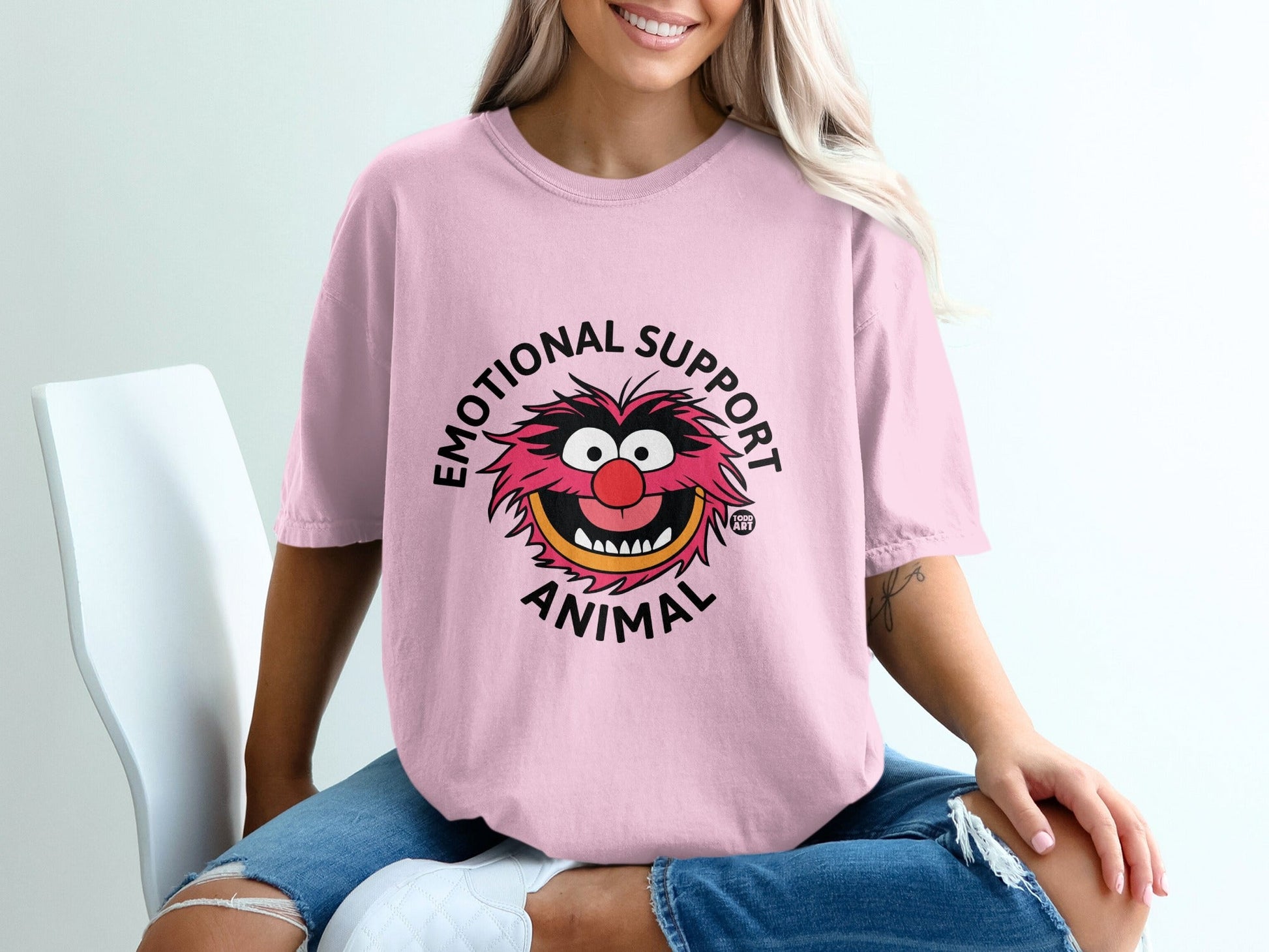 Pink t-shirt with "Emotional Support Animal" text and cartoon animal graphic.