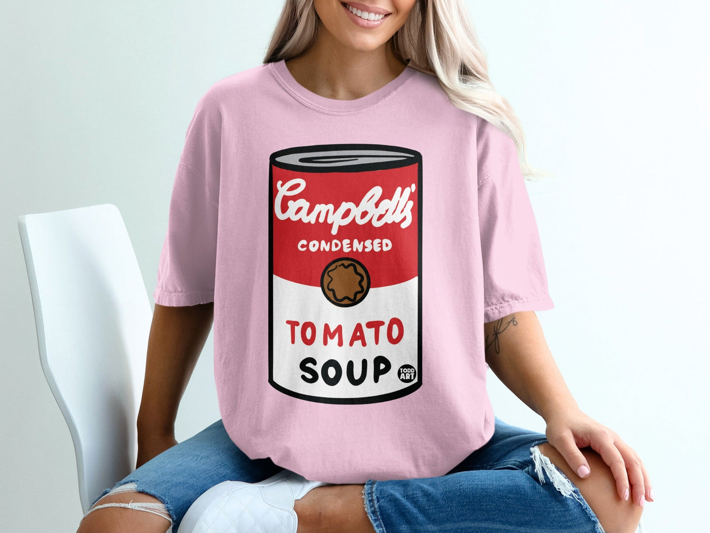 Pink t-shirt with Campbell's Condensed Tomato Soup can graphic.