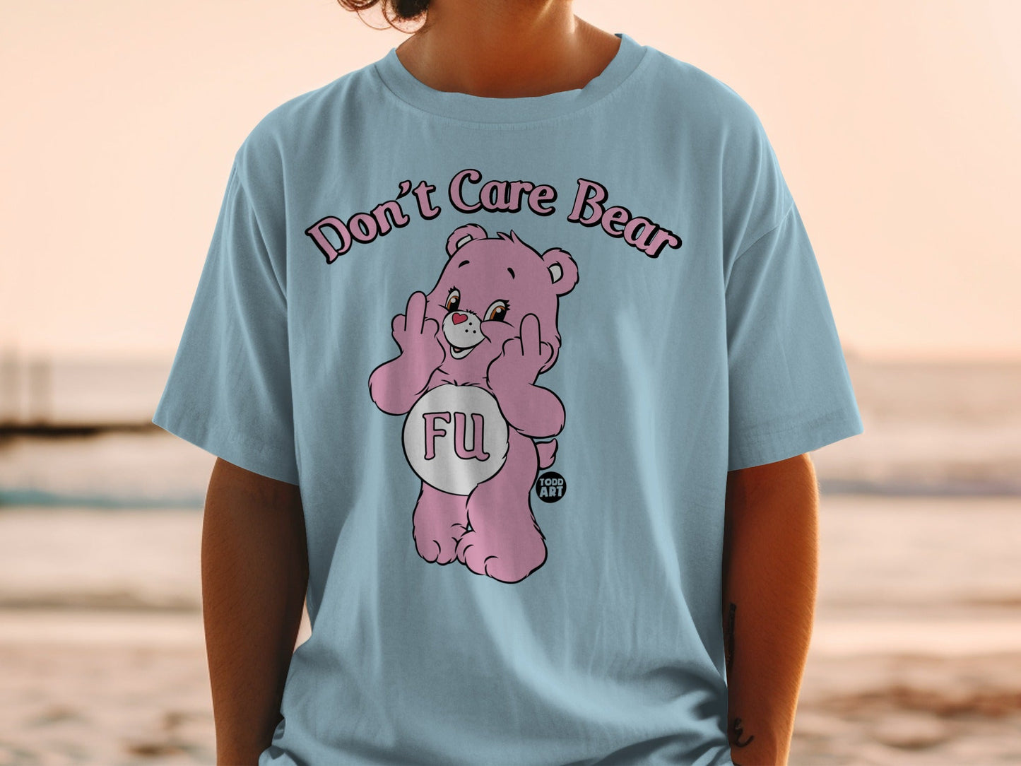 Pink Care Bear t-shirt with "FU" and middle fingers, on a person.