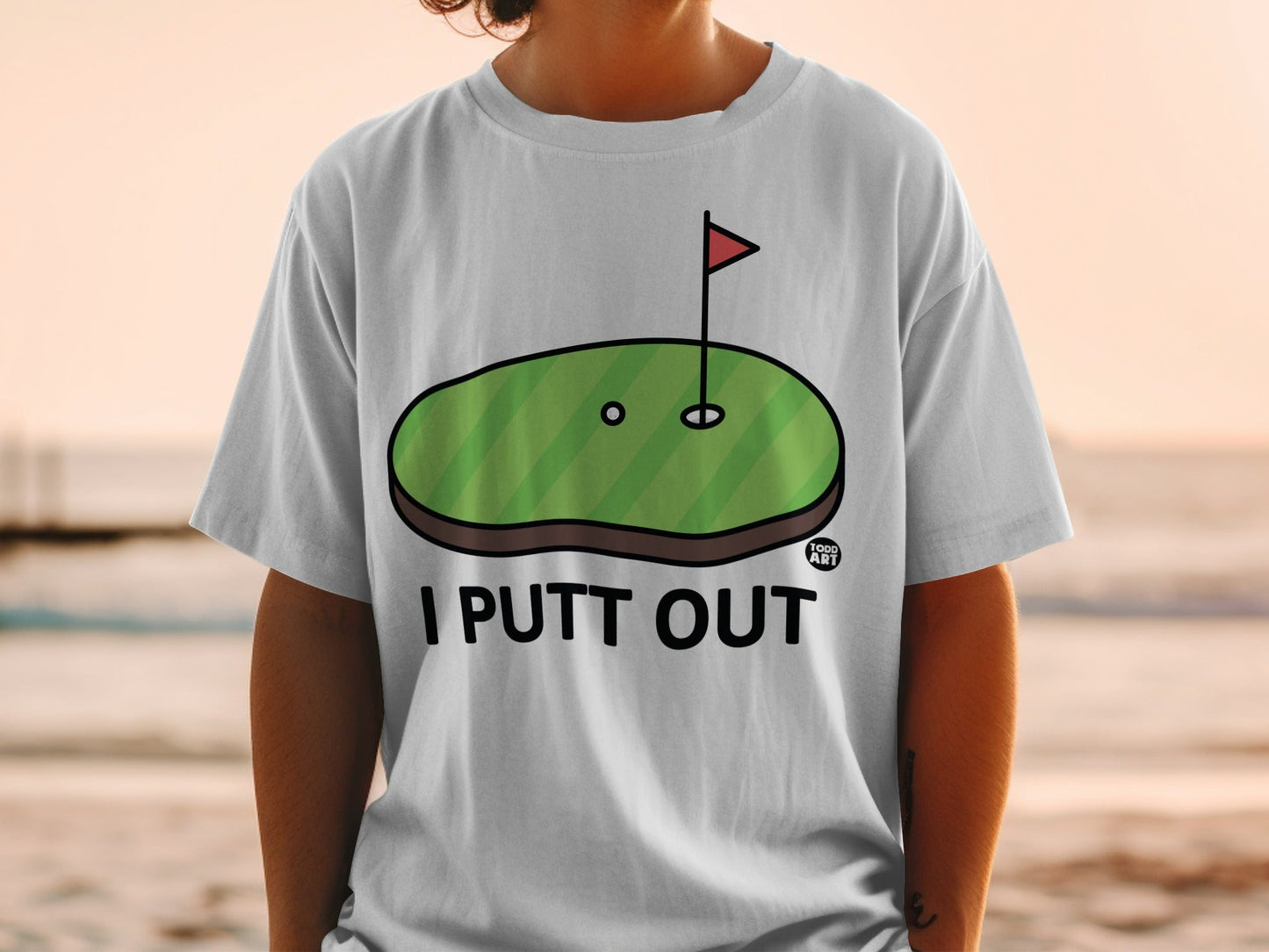 White t-shirt with "I PUTT OUT" and a golf green graphic.