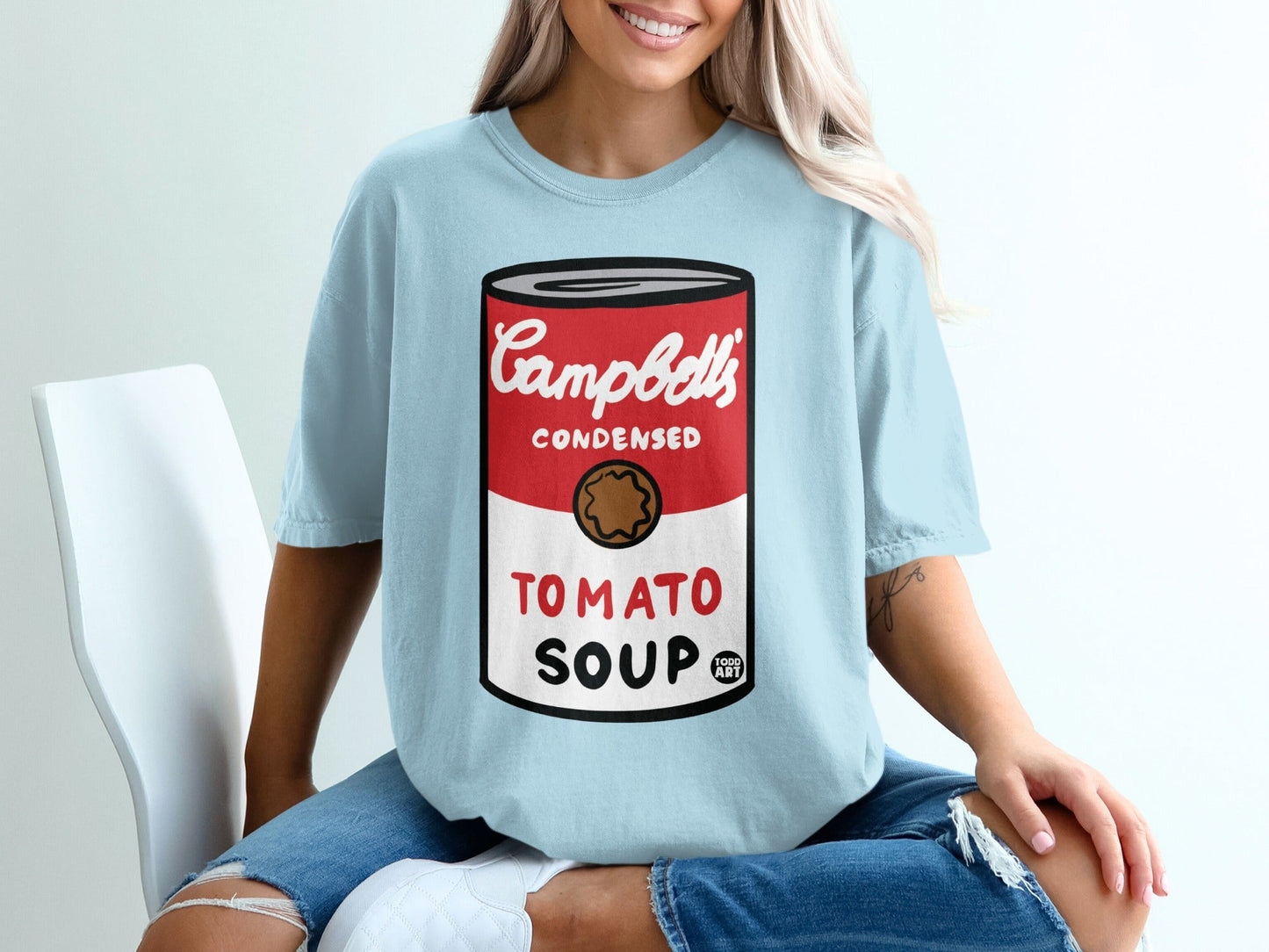 Light blue t-shirt with Campbell's Condensed Tomato Soup can graphic.