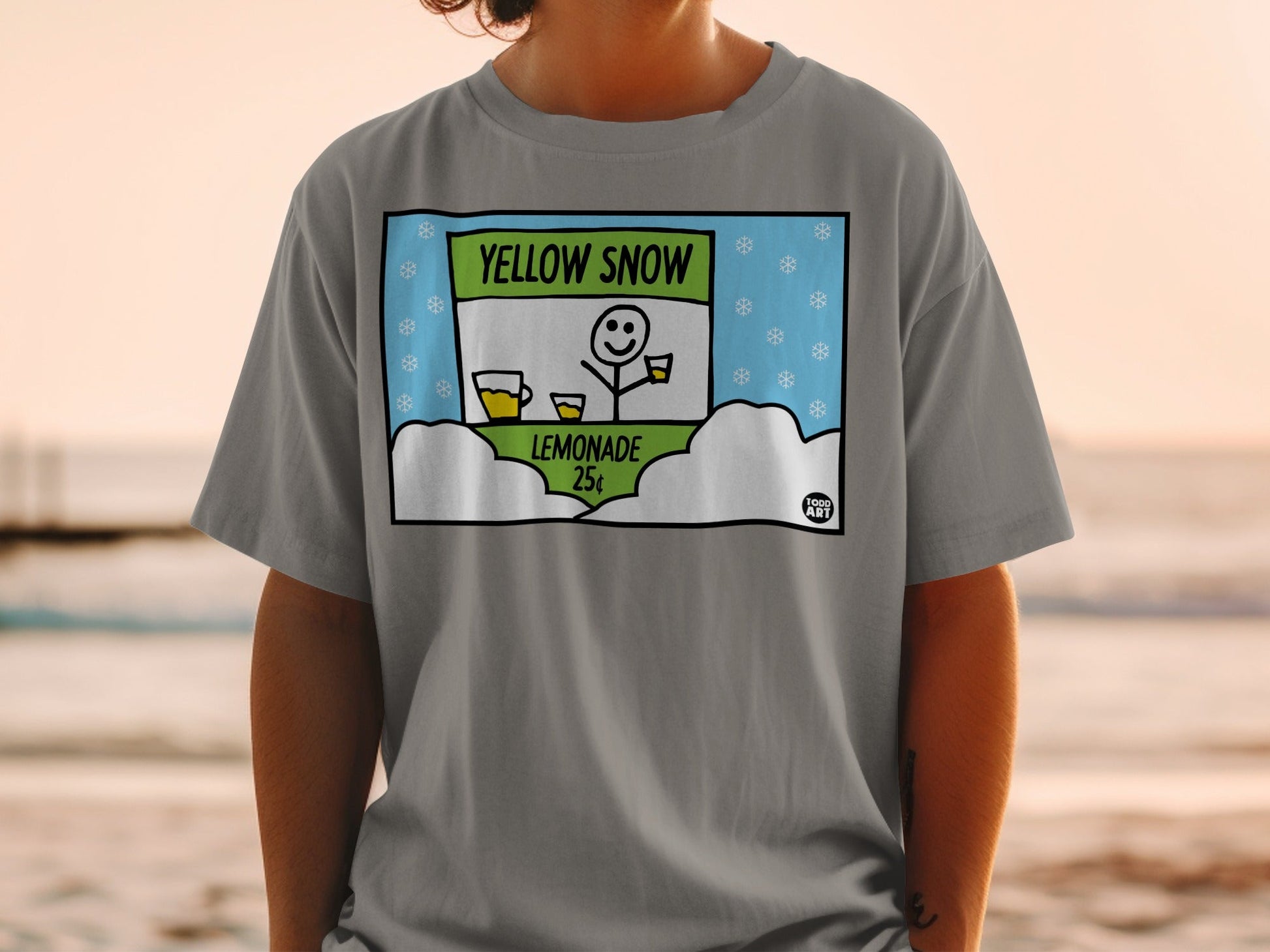 Gray t-shirt featuring "Yellow Snow Lemonade 25¬¢" graphic with a snowman and snowflakes.