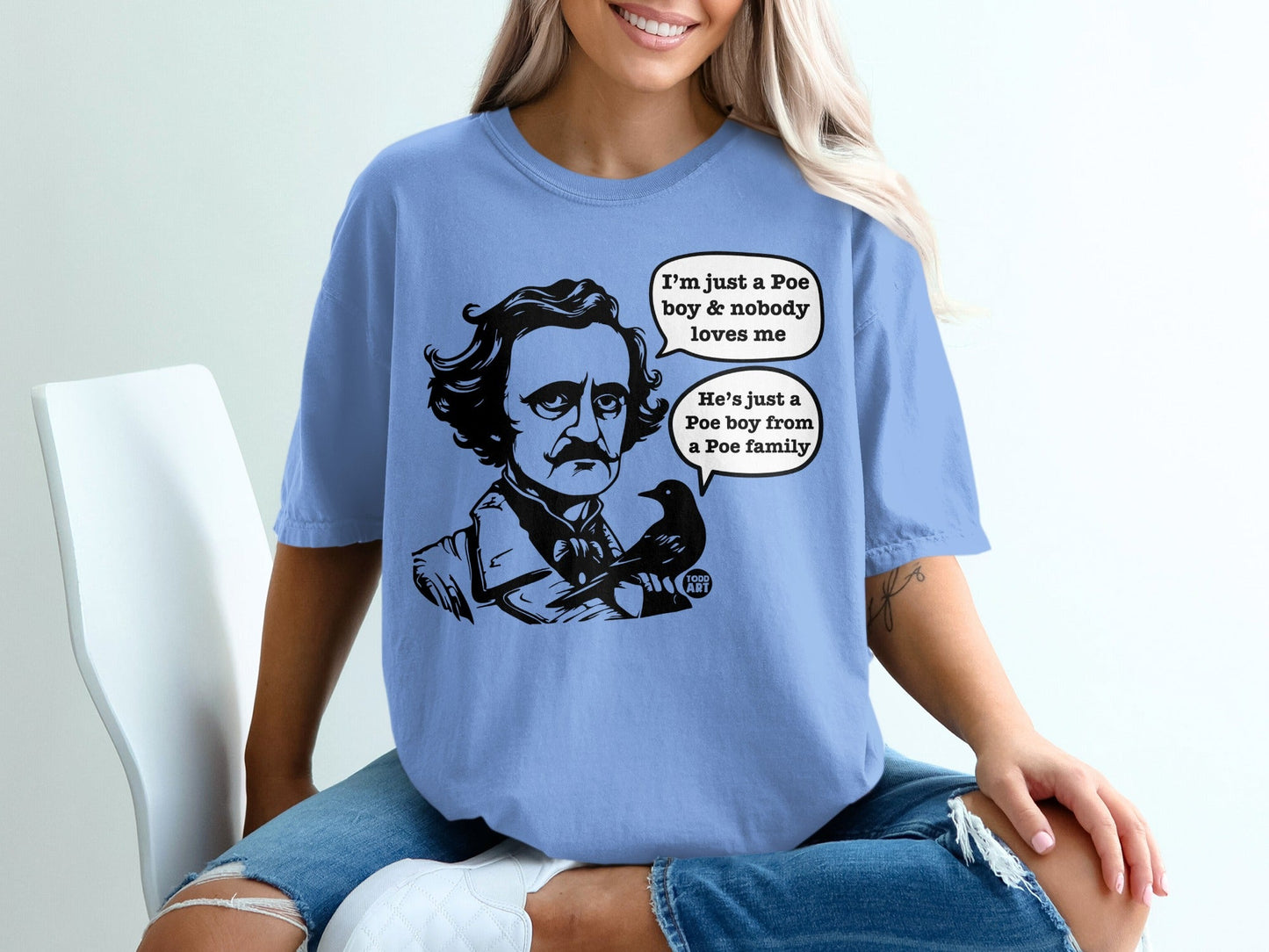 Light blue t-shirt with Edgar Allan Poe and raven illustration and text.