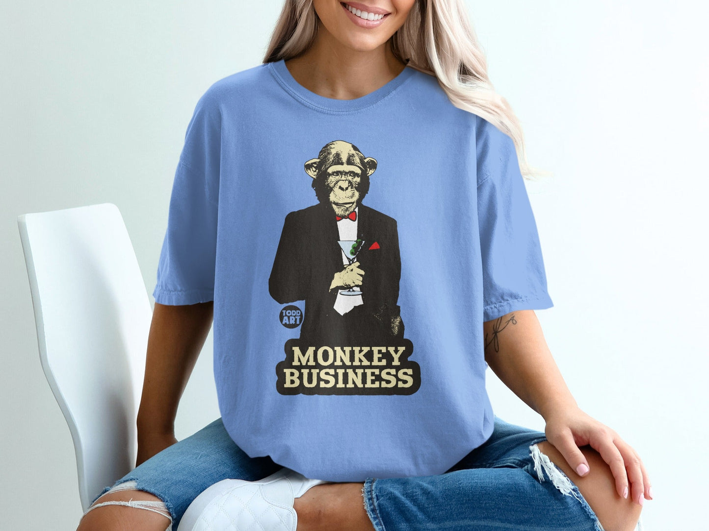 Monkey in a tuxedo holding a martini glass with text "Monkey Business".