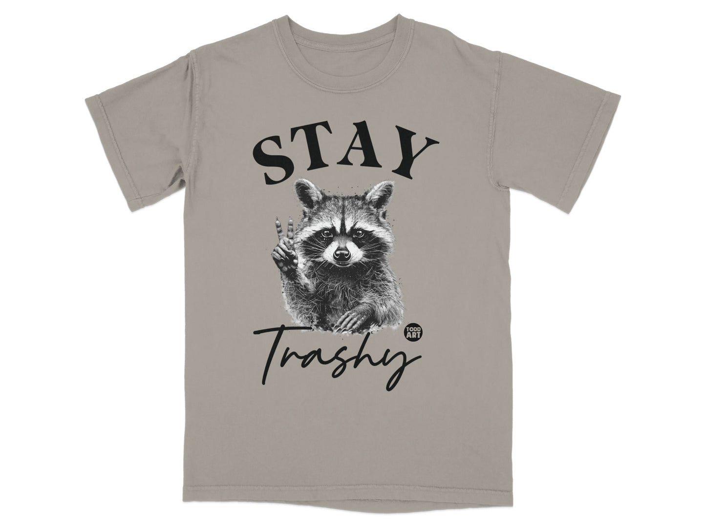 Raccoon giving peace sign on a gray t-shirt with "STAY Trashy" text.