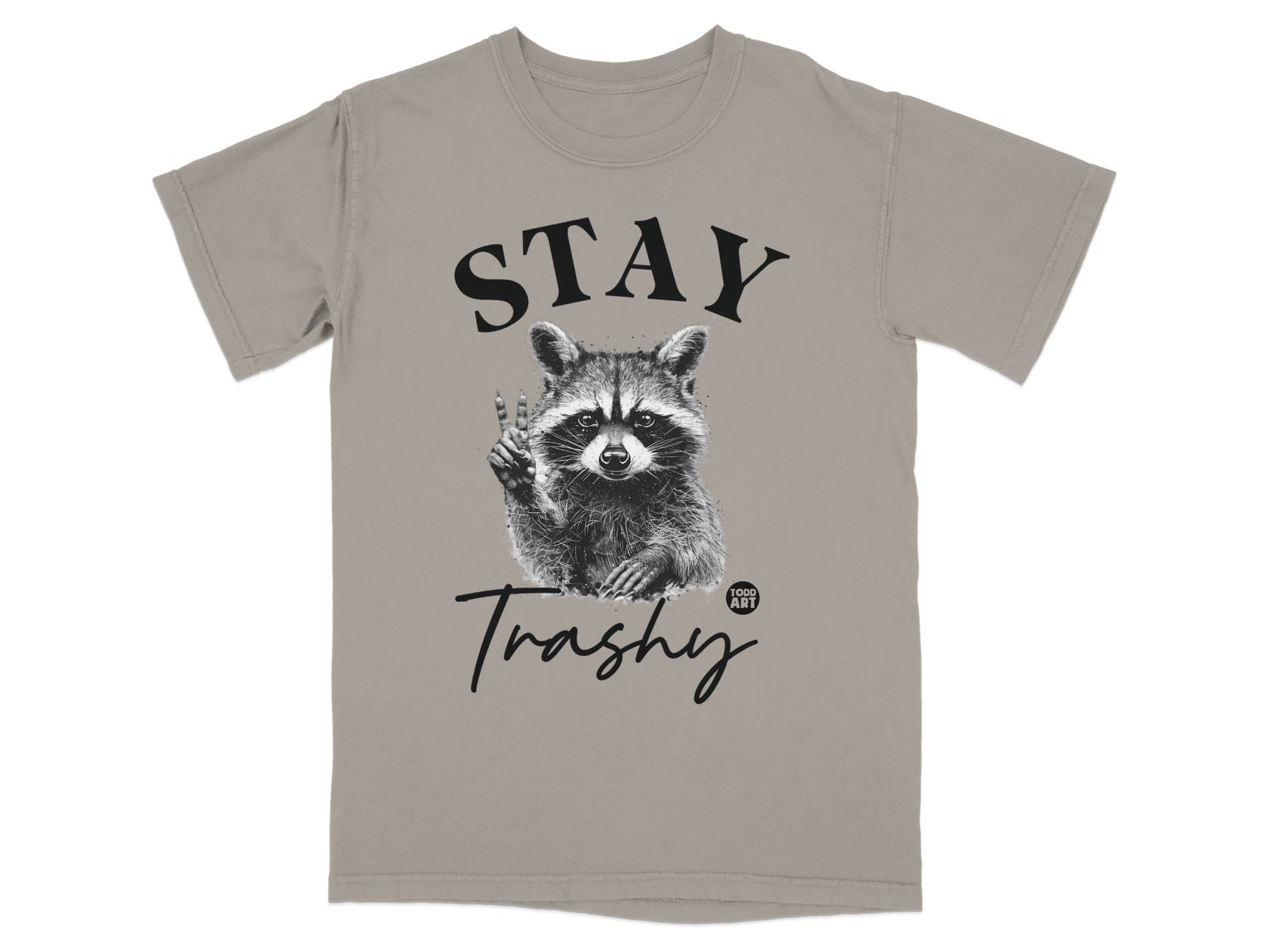 Raccoon giving peace sign on a gray t-shirt with "STAY Trashy" text.