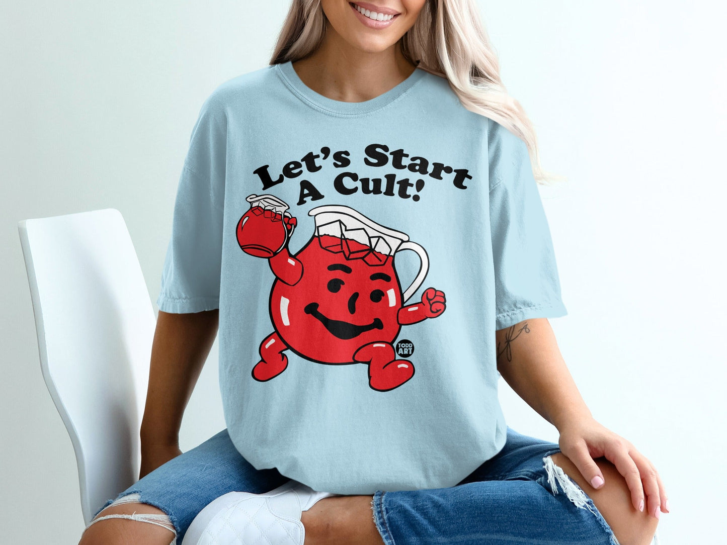 Light blue t-shirt with Kool-Aid Man character and "Let's Start A Cult!" text.