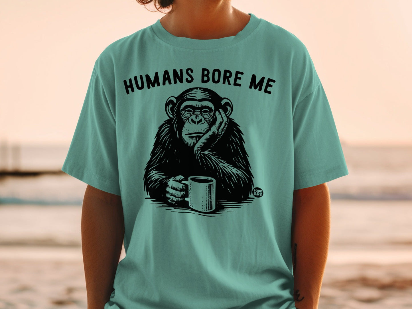 T-shirt with a chimpanzee holding a coffee cup, text reads "HUMANS BORE ME".