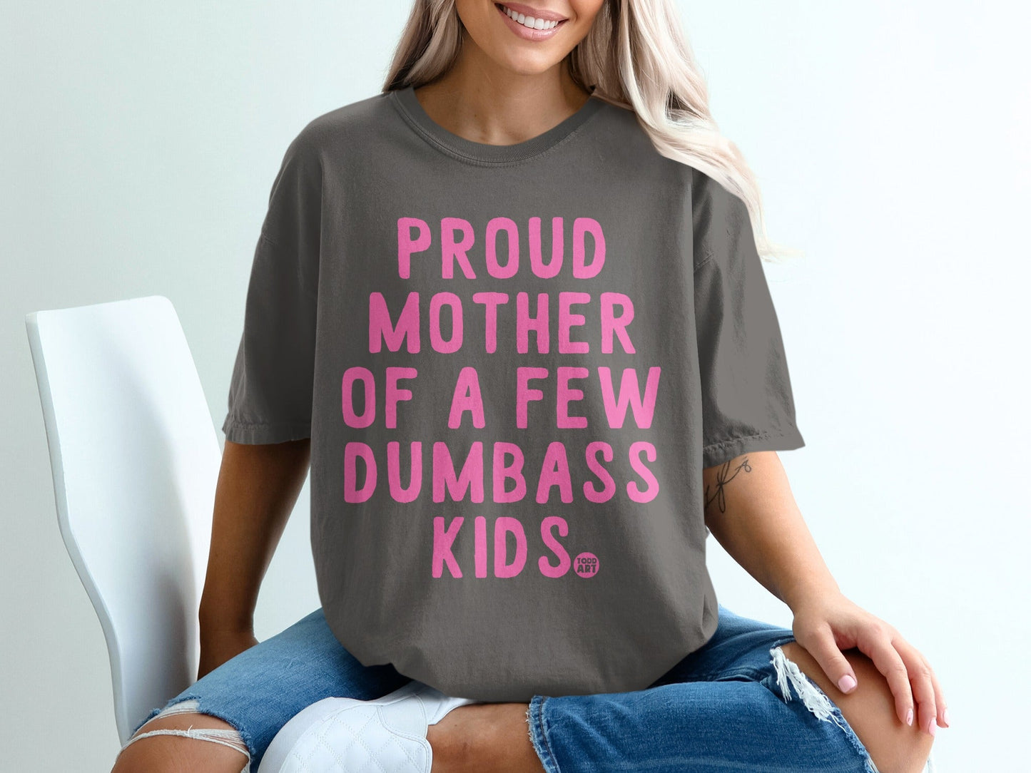 Charcoal t-shirt with "Proud Mother of a Few Dumbass Kids" in pink lettering.