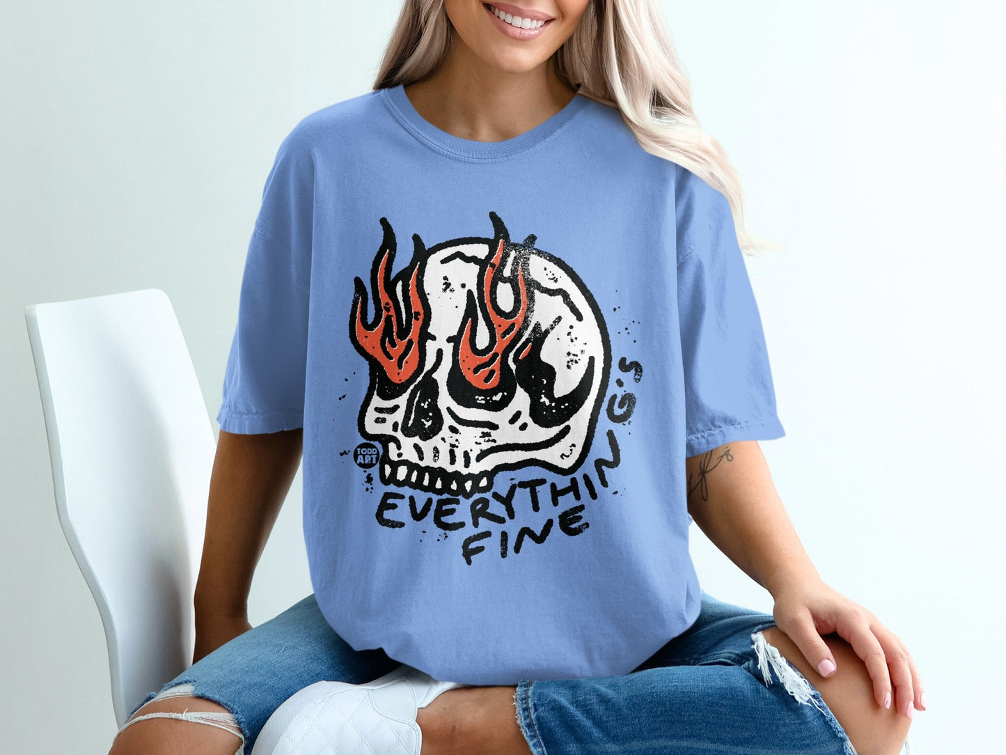 Blue t-shirt with a flaming skull graphic and text "EVERYTHIN FINE".