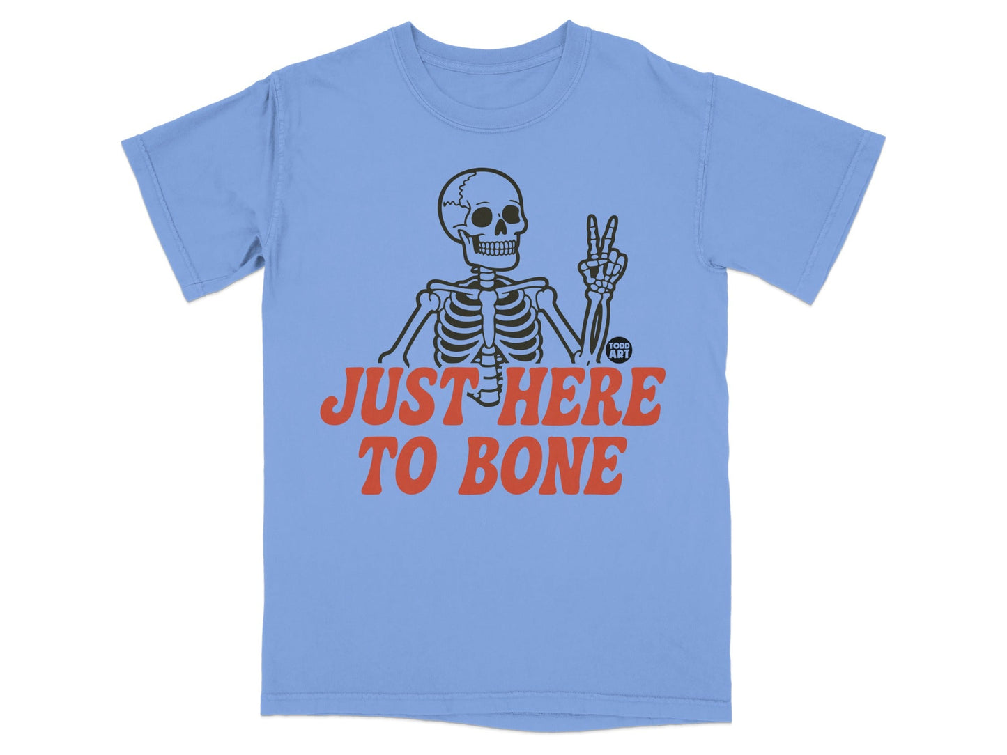 Skeleton giving peace sign on light blue t-shirt with "JUST HERE TO BONE" text.