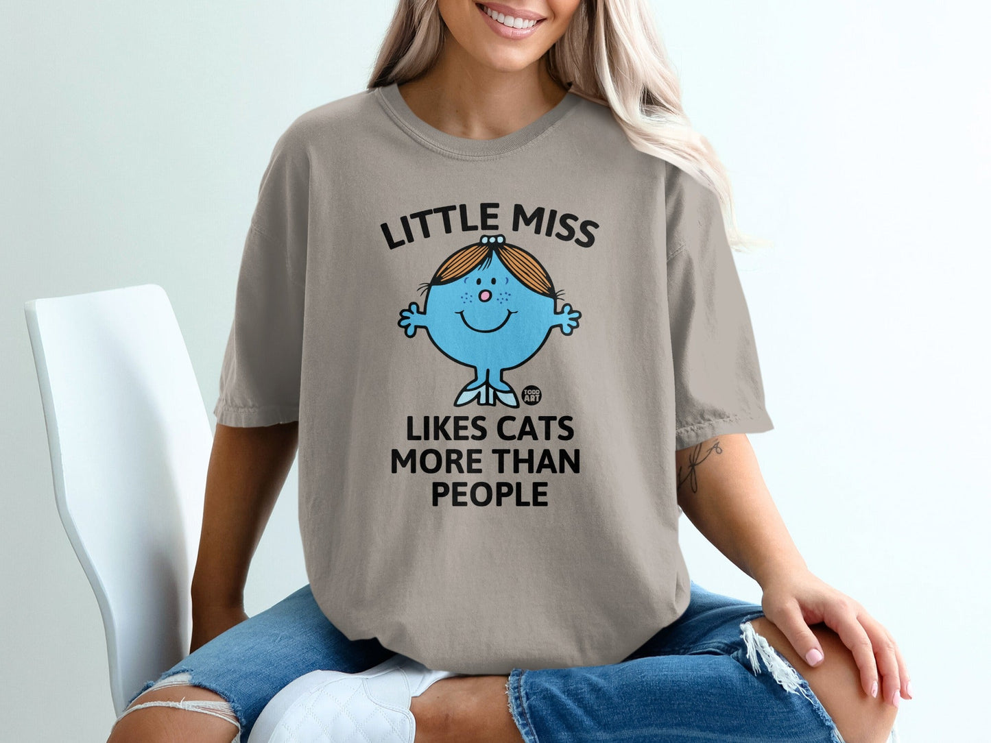 T-shirt with "Little Miss Likes Cats More Than People" text and character.
