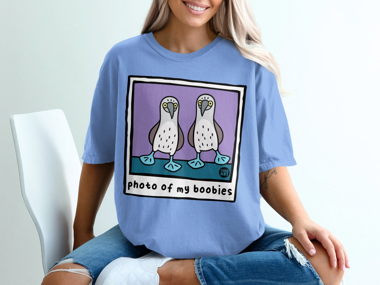 Blue t-shirt featuring a cartoon of two boobies with text "photo of my boobies" below.