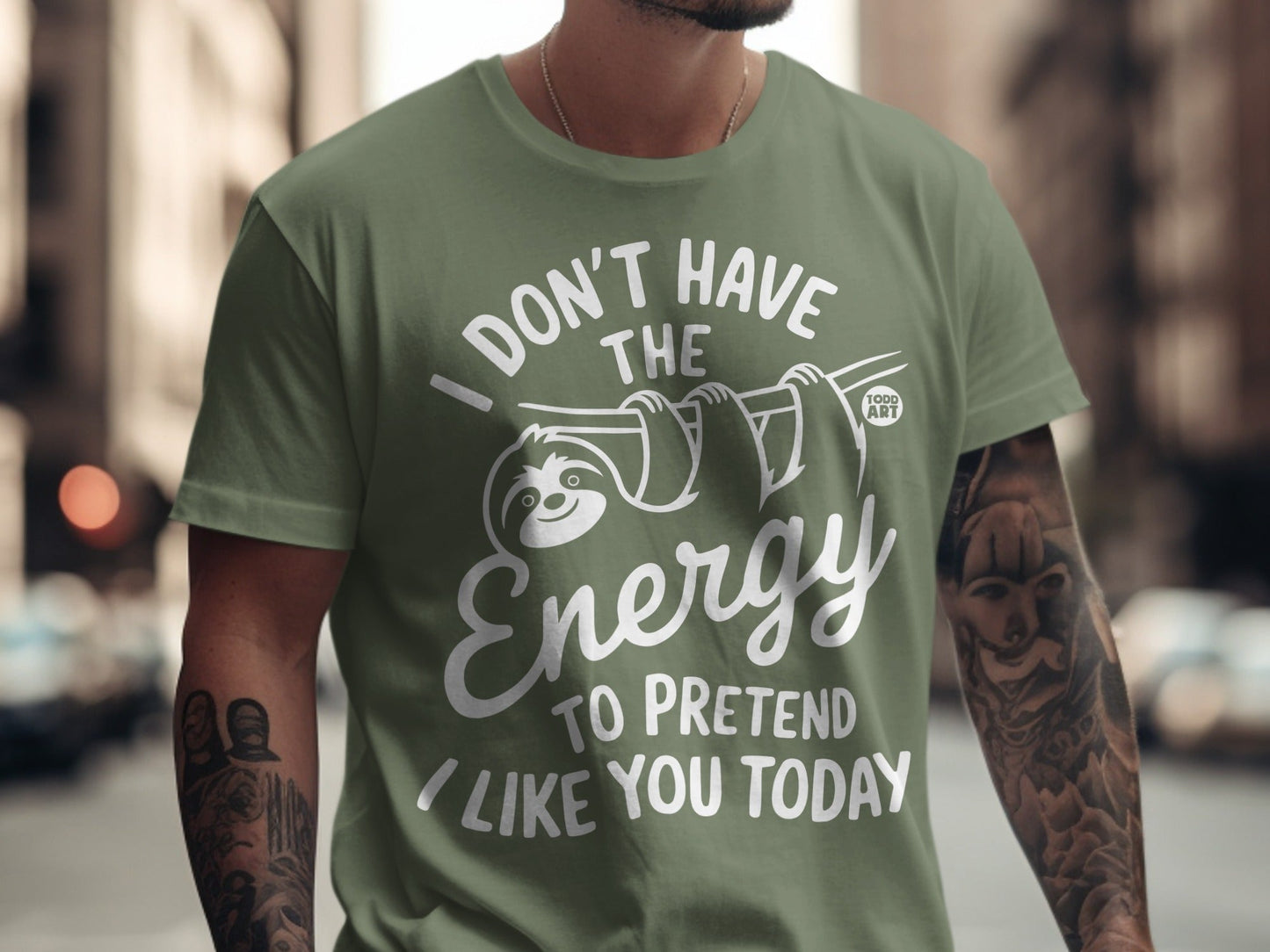 Olive green t-shirt with white text and sloth graphic saying "I Don't Have The Energy To Pretend I Like You Today."