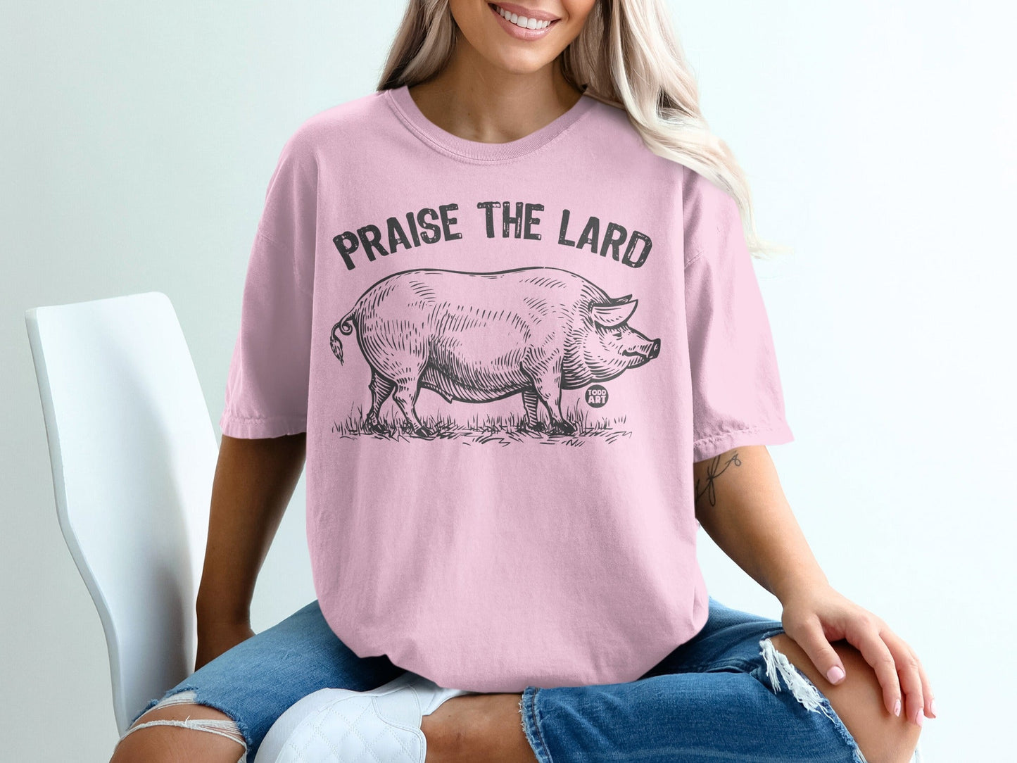 Pink t-shirt with black line art of a pig and "Praise the Lard" text.
