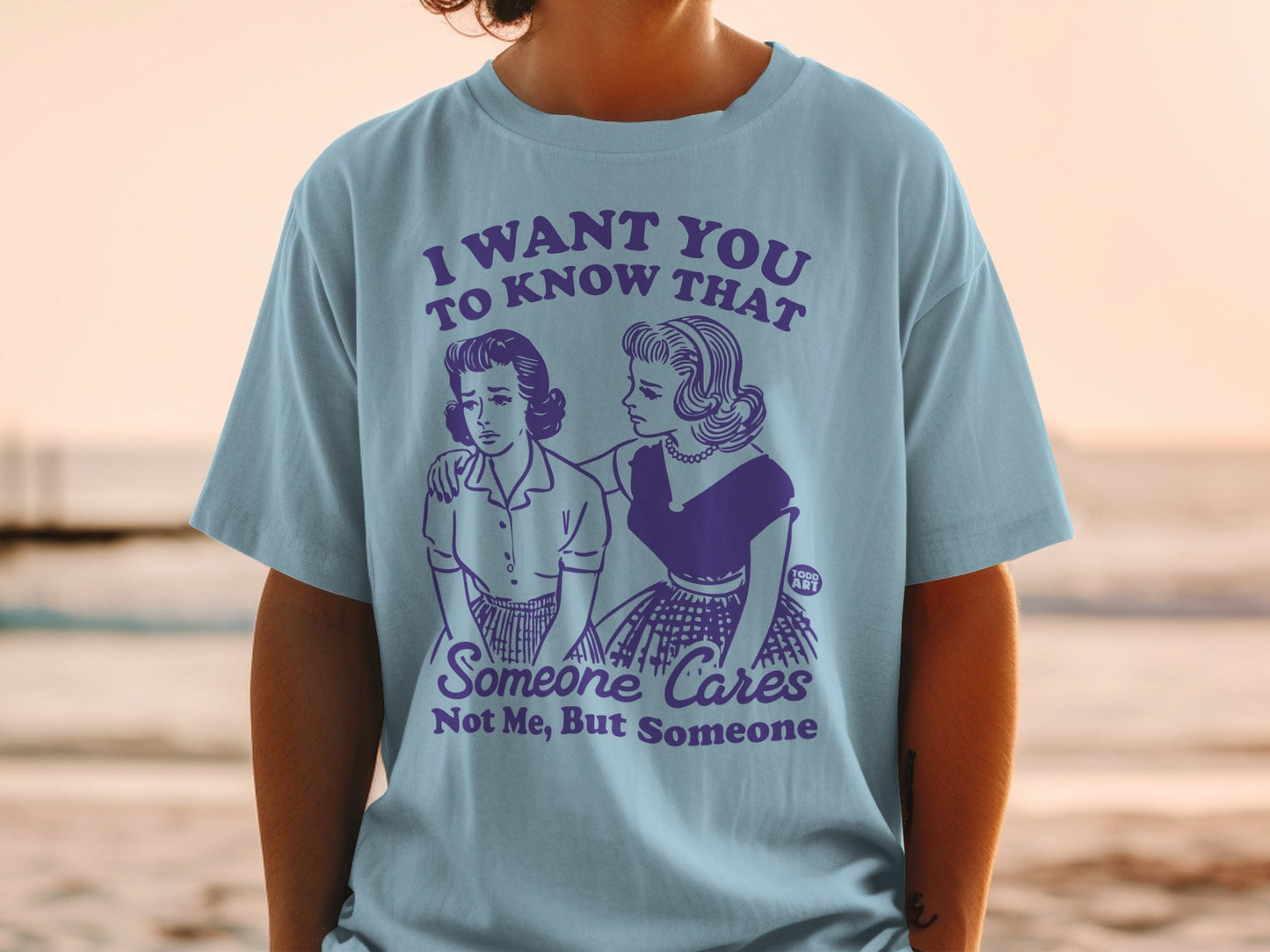 T-shirt with "Someone Cares Not Me, But Someone" graphic.