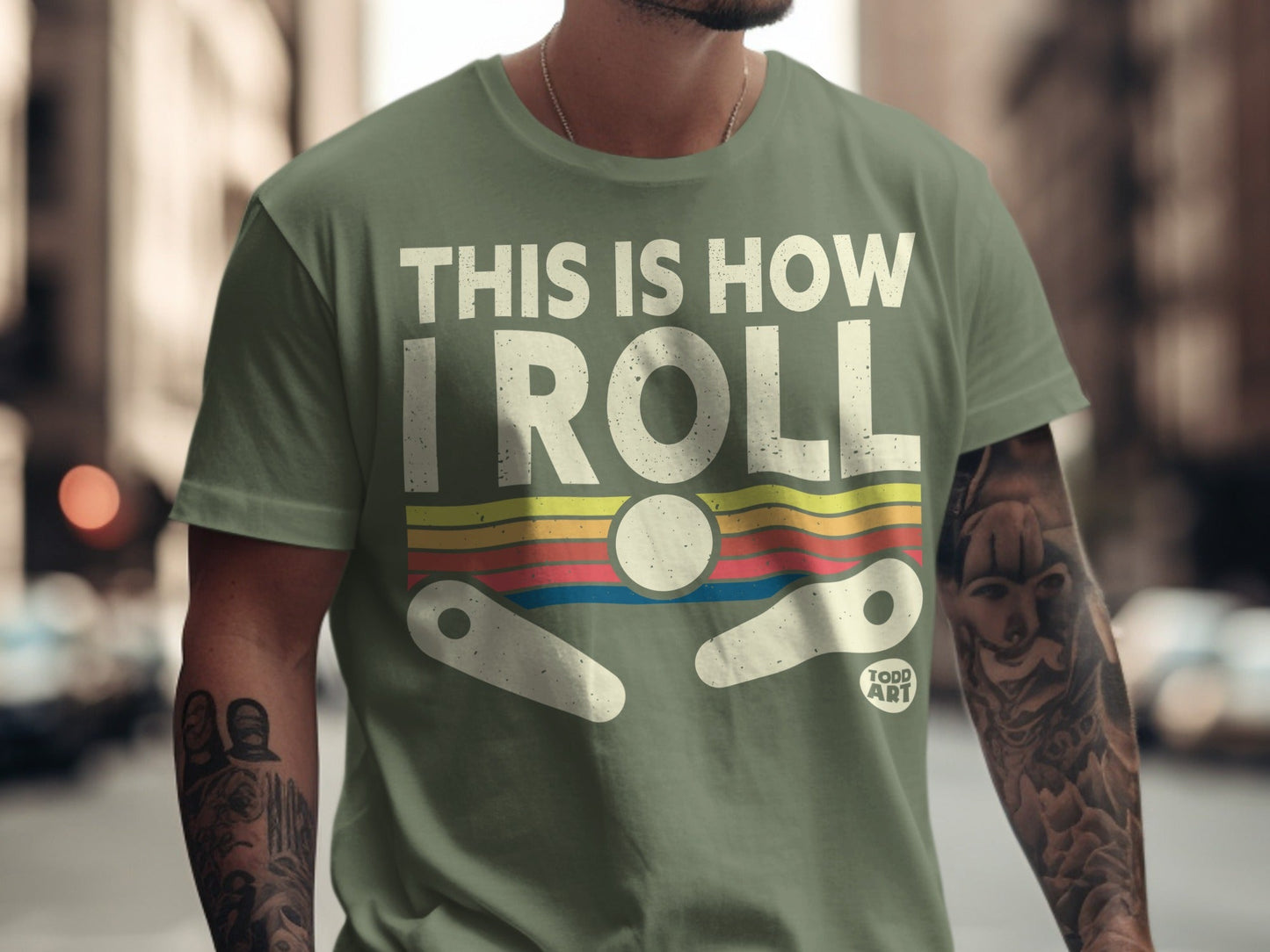 Green t-shirt with "THIS IS HOW I ROLL" and pinball graphic.