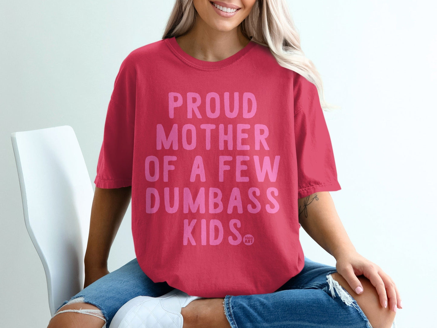 Pink t-shirt with "Proud Mother of a Few Dumbass Kids" text.