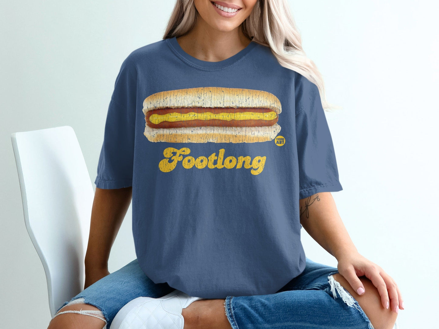 Blue t-shirt with a footlong hot dog and "FOOTLONG" text graphic.