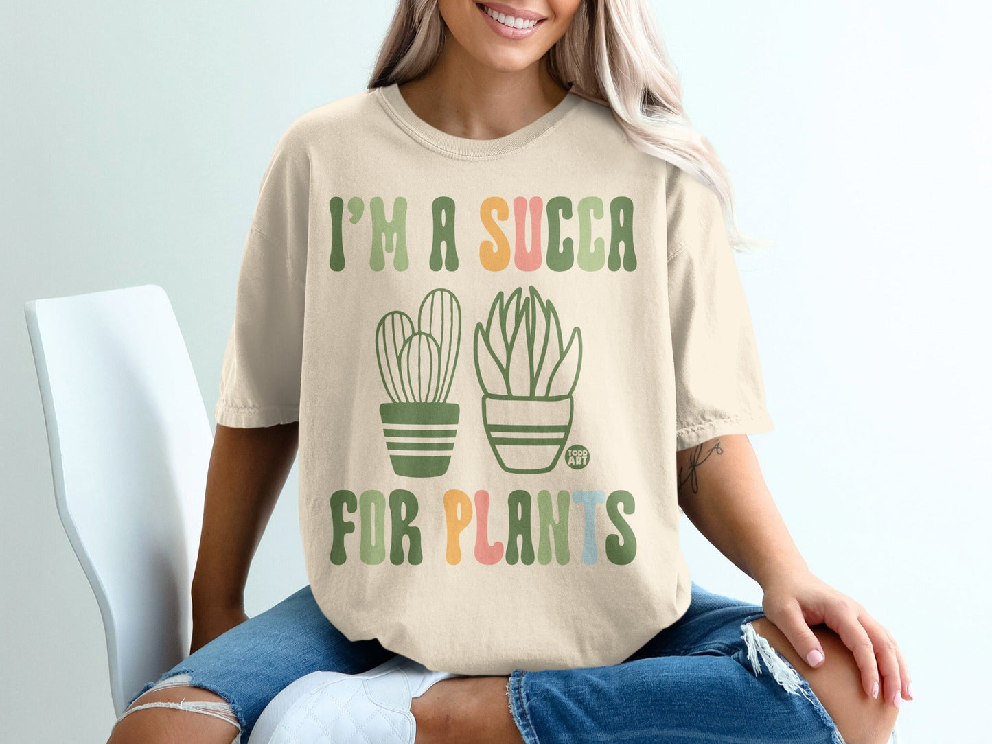 "I'm a succa for plants" text with two potted succulents on a tan t-shirt.