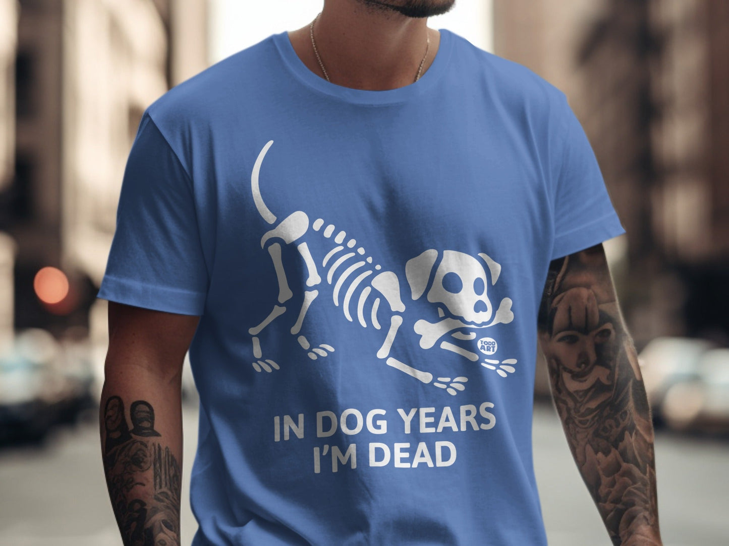 Blue t-shirt with white dog skeleton graphic and "IN DOG YEARS I'M DEAD" text.