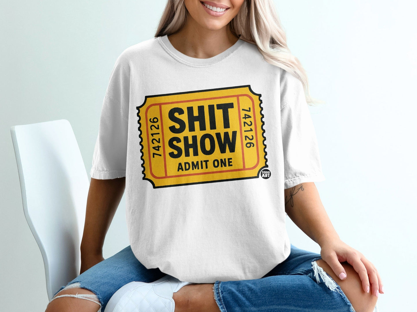 White t-shirt with ticket design: "SHIT SHOW ADMIT ONE"