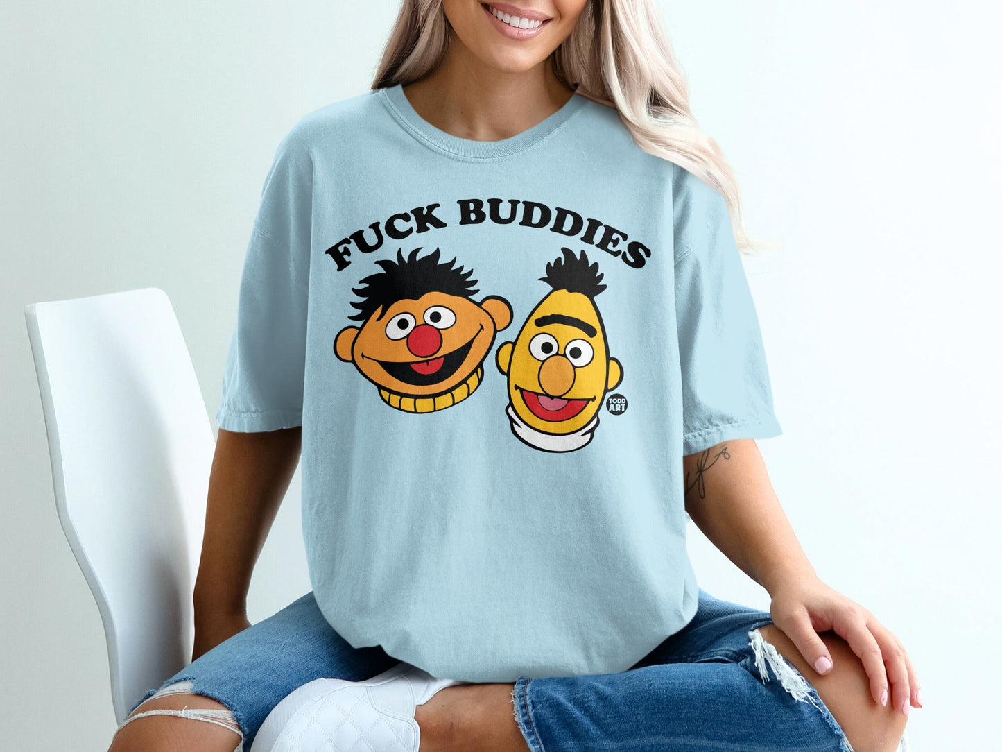 Light blue t-shirt featuring cartoon characters Bert and Ernie with "FUCK BUDDIES" text.