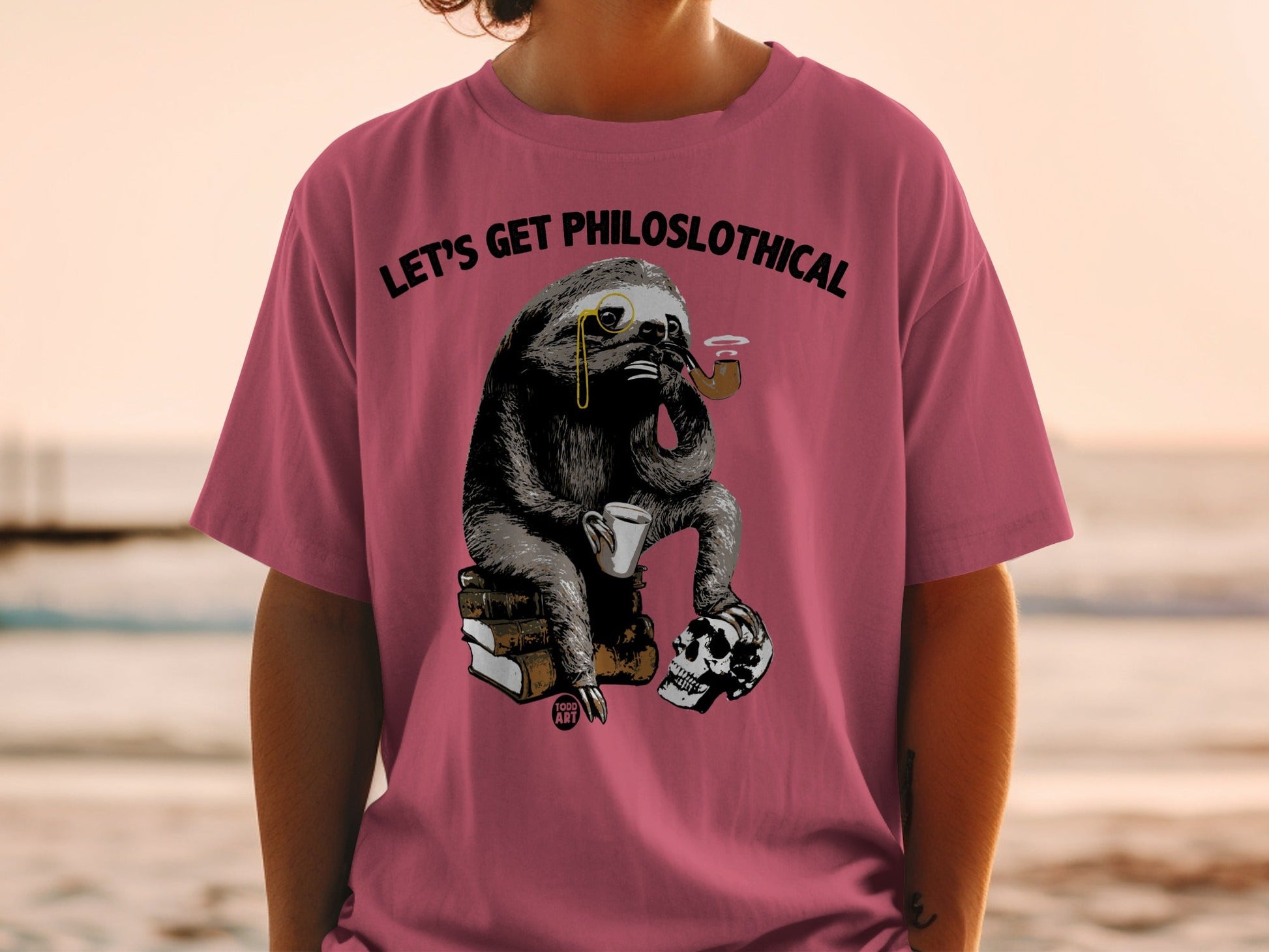 T-shirt with sloth wearing monocle, smoking pipe, holding mug, with skull and books.