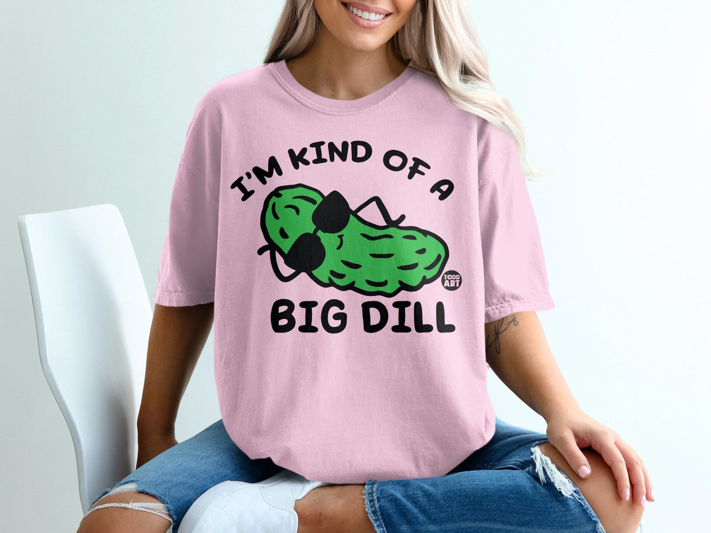 Pink t-shirt with graphic of pickle wearing sunglasses, text reads "I'm kind of a big dill".
