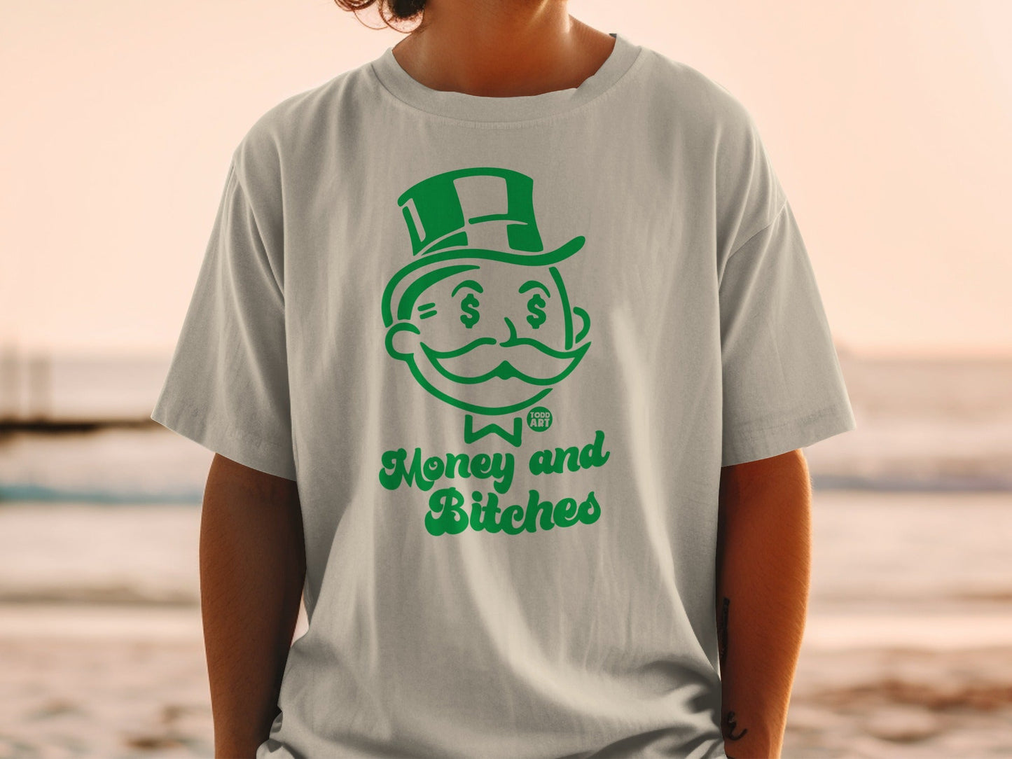 T-shirt with green cartoon Monopoly Man and "Money and Bitches" text.