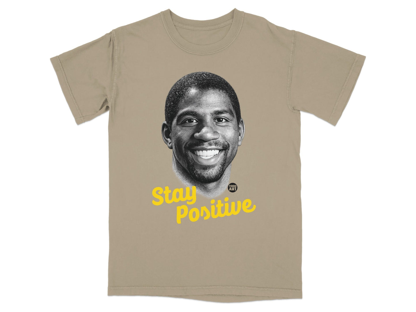 Magic Johnson portrait on a tan t-shirt with "Stay Positive" text.