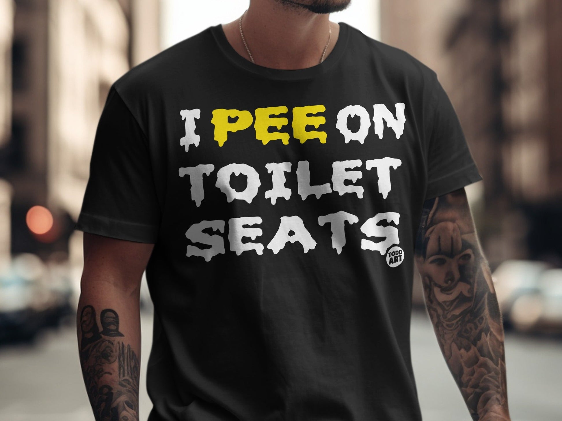 Black t-shirt with "I PEE ON TOILET SEATS" in white and yellow text.