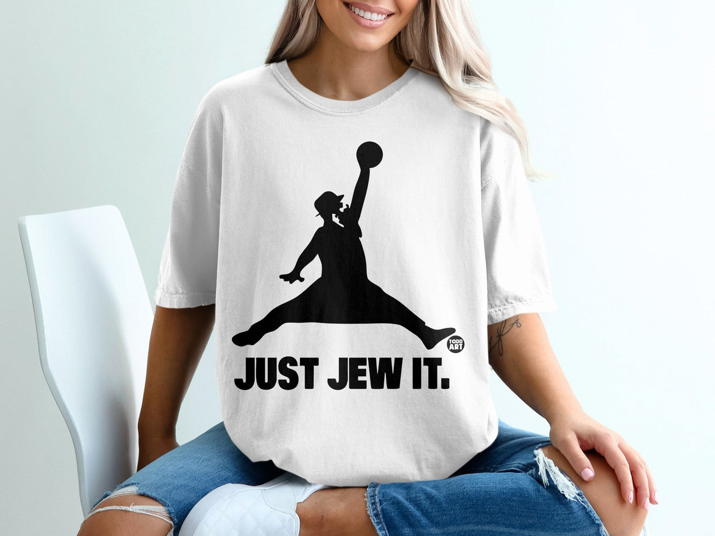 White t-shirt with black silhouette of a leaping figure holding a basketball, "JUST JEW IT."