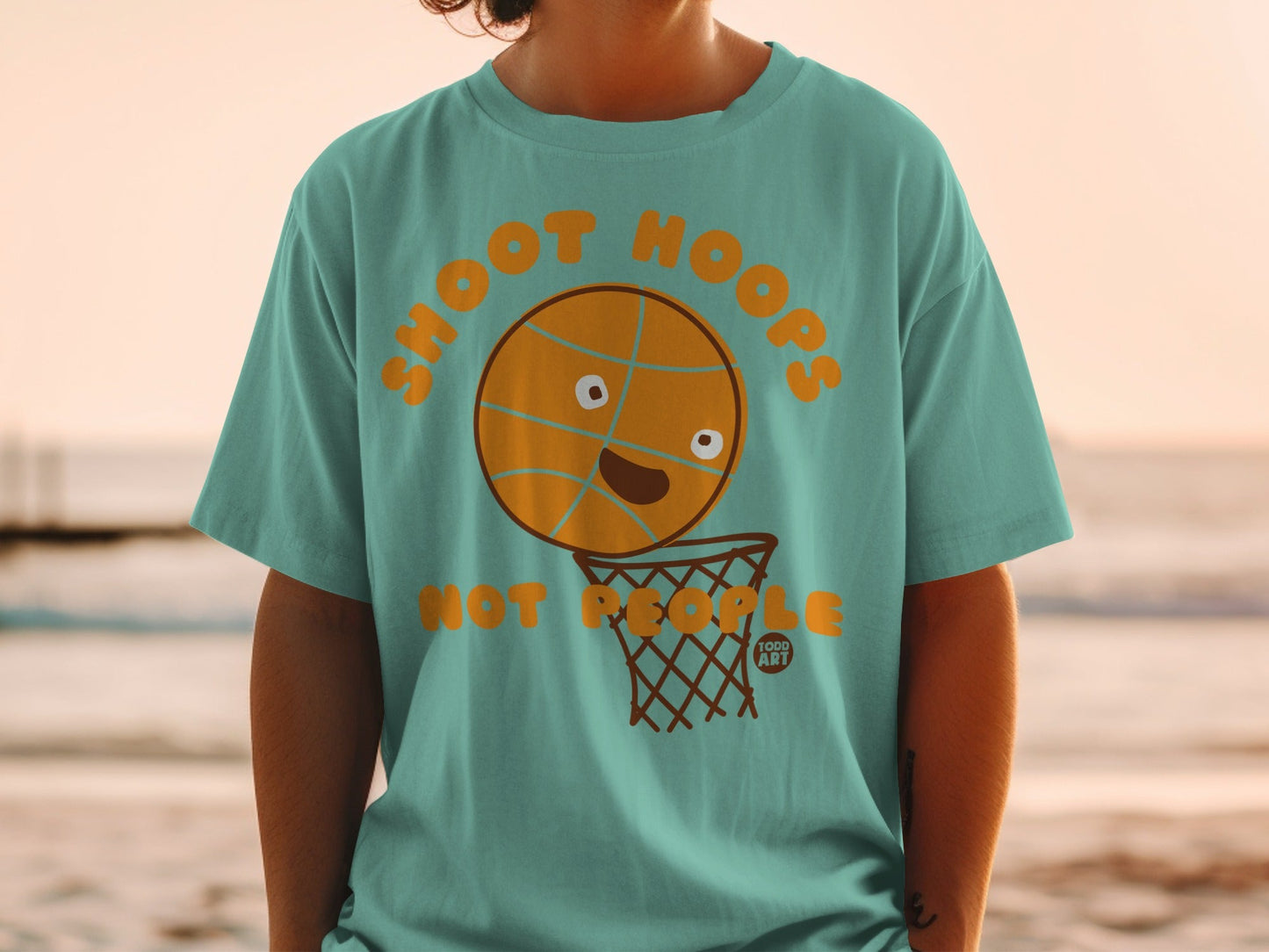 Teal t-shirt with a cartoon basketball about to score in a hoop.