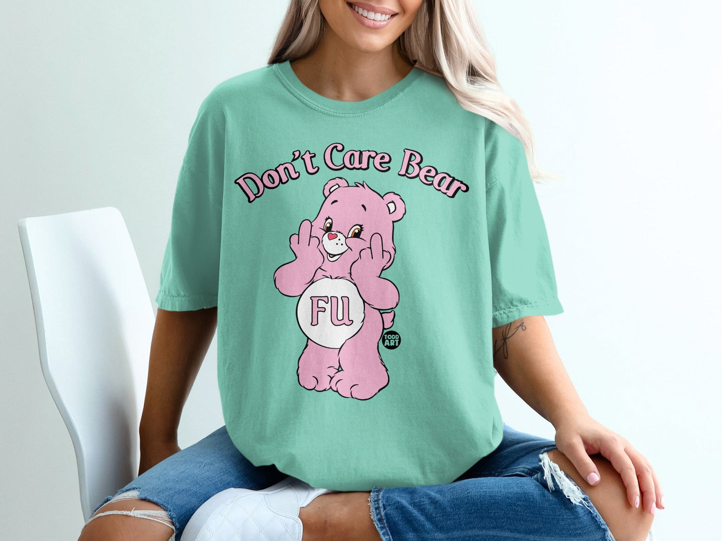 Pink Care Bear with "FU" on its belly giving middle fingers.