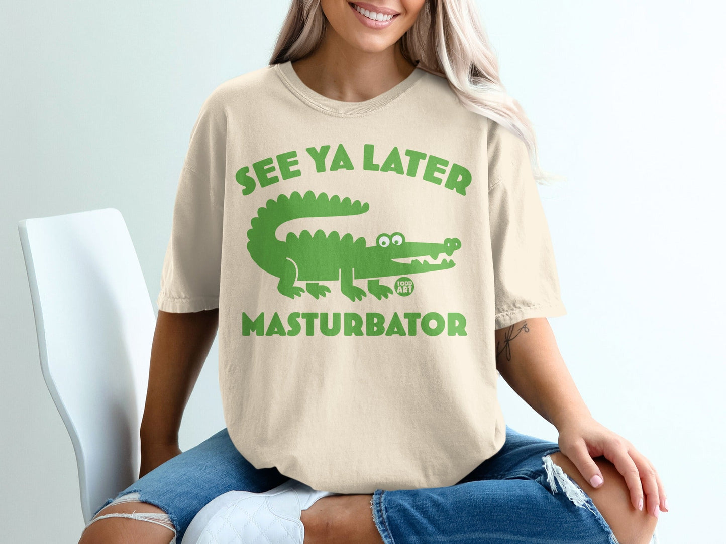 Cream t-shirt with green alligator graphic and text "SEE YA LATER MASTURBATOR".