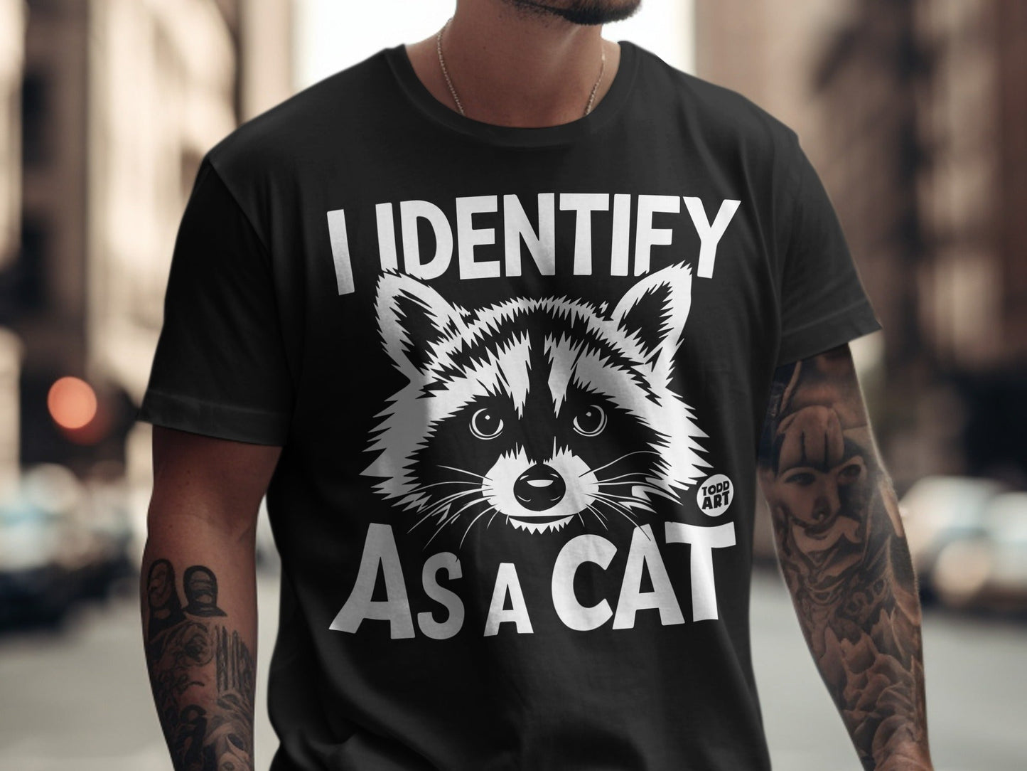 Black t-shirt with "I IDENTIFY AS A CAT" and raccoon graphic.