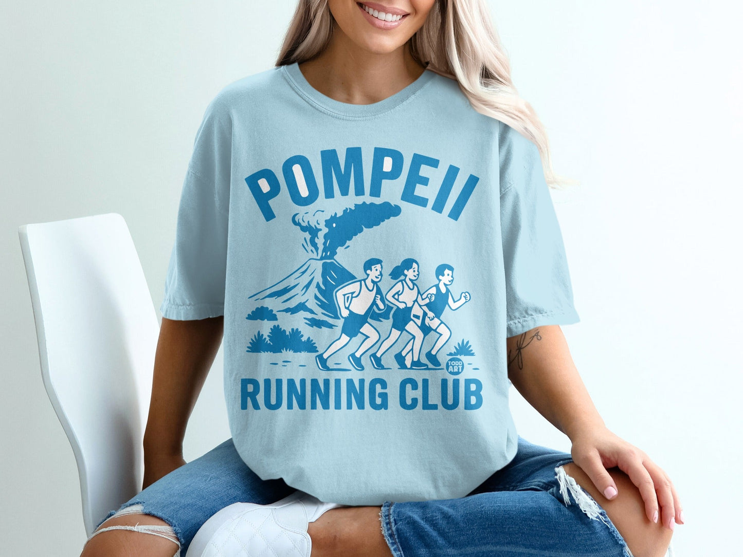 Light blue t-shirt with "Pompeii Running Club" text and graphic of runners.