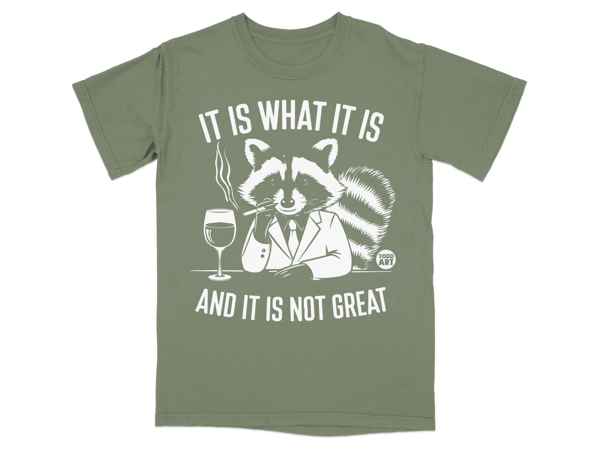 T-shirt with a raccoon wearing a suit, smoking, and drinking, text "IT IS WHAT IT IS AND IT IS NOT GREAT".
