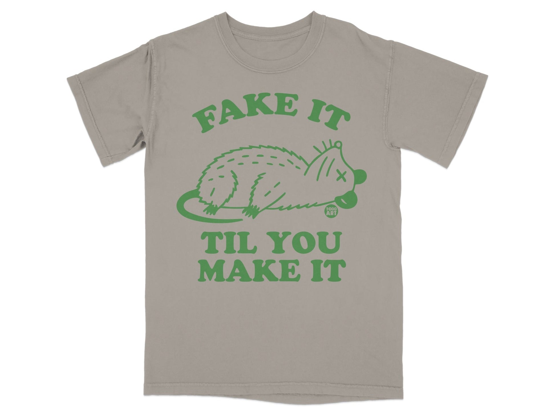 T-shirt with green cartoon possum and text "FAKE IT TIL YOU MAKE IT".